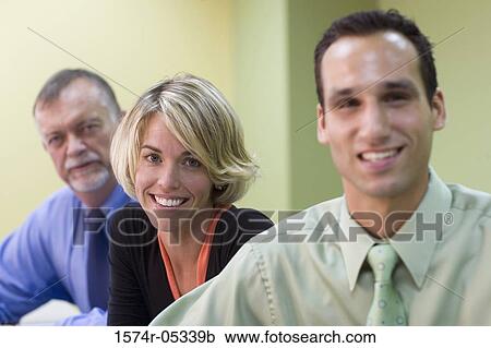 Portrait of two businessmen and a businesswoman sitting in a conference room View Large Photo Image Stock Image - Portrait of two businessmen and a businesswoman sitting in a conference room. Fotosearch