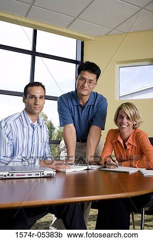 Portrait of two businessmen and a businesswoman in a conference room View Large Photo Image Stock Image - Portrait of two businessmen and a businesswoman in a conference room. Fotosearch