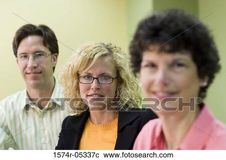 Portrait of two businesswomen and a businessman sitting in a conference room View Large Photo Image Stock Image - Portrait of two businesswomen and a businessman sitting in a conference room. Fotosearch