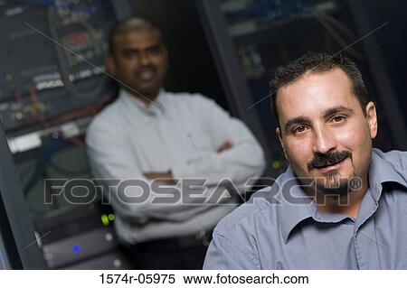 Stock Photography - Portrait of two technicians in a server room. Fotosearch