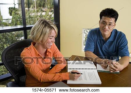 Businessman and a businesswoman in a conference View Large Photo Image Stock Image - Businessman and a businesswoman in a conference. Fotosearch