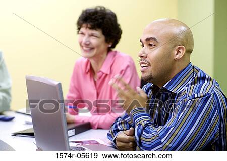 Businessman and a businesswoman in a conference View Large Photo Image Stock Photo - Businessman and a businesswoman in a conference. Fotosearch