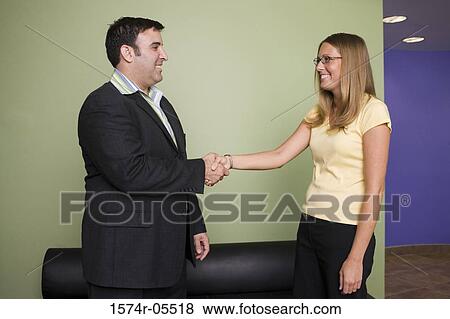 Businessman and a businesswoman shaking hands View Large Photo Image Stock Photo - Businessman and a businesswoman shaking hands. Fotosearch