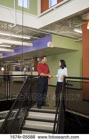 Businessman and a businesswoman shaking hands View Large Photo Image Stock Photo - Businessman and a businesswoman shaking hands. Fotosearch