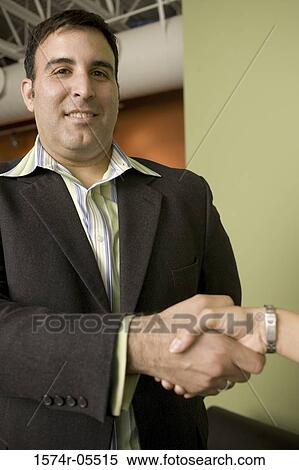 Businessman and a businesswoman shaking hands View Large Photo Image Stock Photography - Businessman and a businesswoman shaking hands. Fotosearch