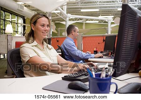 Businessman and a businesswoman using computers View Large Photo Image Stock Image - Businessman and a businesswoman using computers. Fotosearch