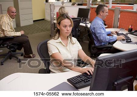 Stock Image - Businessman and a businesswoman using computers. Fotosearch