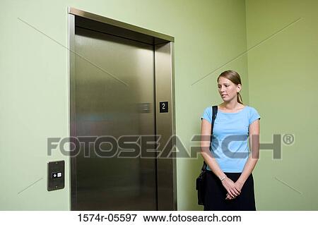 Businesswoman waiting for an elevator View Large Photo Image Stock Photo - Businesswoman waiting for an elevator. Fotosearch
