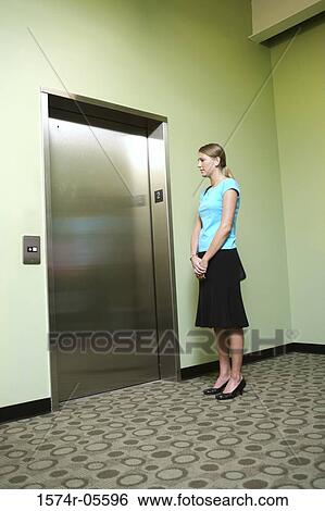 Businesswoman waiting for an elevator View Large Photo Image Stock Photograph - Businesswoman waiting for an elevator. Fotosearch