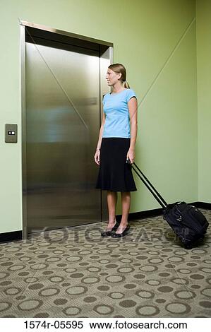 Businesswoman waiting for an elevator View Large Photo Image Stock Photography - Businesswoman waiting for an elevator. Fotosearch
