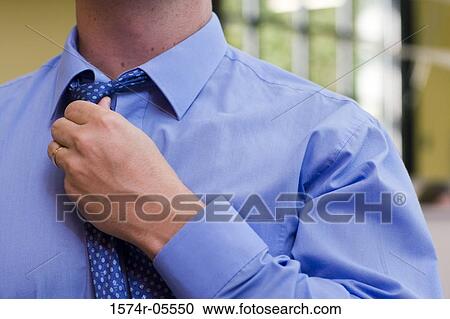 Close-up of a businessman adjusting his tie View Large Photo Image Stock Image - Close-up of a businessman adjusting his tie. Fotosearch