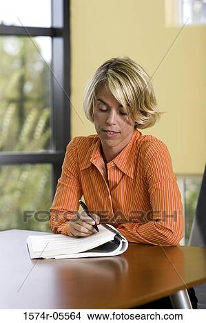 Close-up of a businesswoman reading documents View Large Photo Image Picture - Close-up of a businesswoman reading documents. Fotosearch