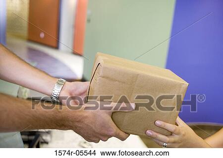 Delivery man delivering a parcel View Large Photo Image Picture - Delivery man delivering a parcel. Fotosearch