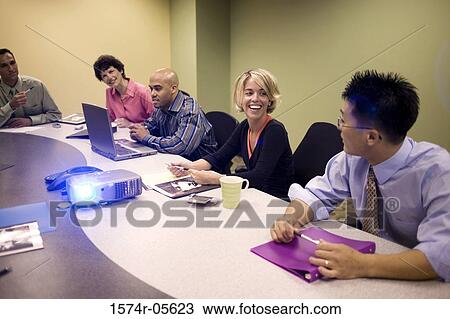 Stock Image - Group of business executives in a conference. Fotosearch