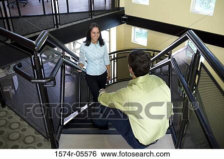 High angle view of a businessman and a businesswoman on stairs View Large Photo Image Stock Photograph - High angle view of a businessman and a businesswoman on stairs. Fotosearch