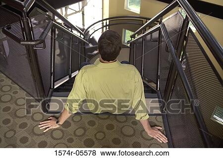 High angle view of a businessman sitting on stairs View Large Photo Image Stock Photo - High angle view of a businessman sitting on stairs. Fotosearch