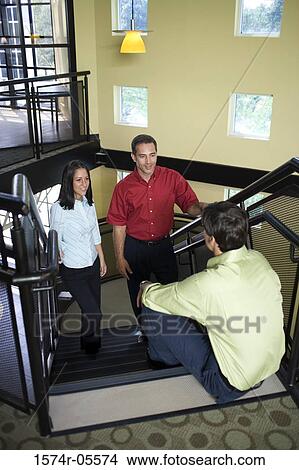 High angle view of two businessmen and a businesswoman on stairs View Large Photo Image Picture - High angle view of two businessmen and a businesswoman on stairs. Fotosearch