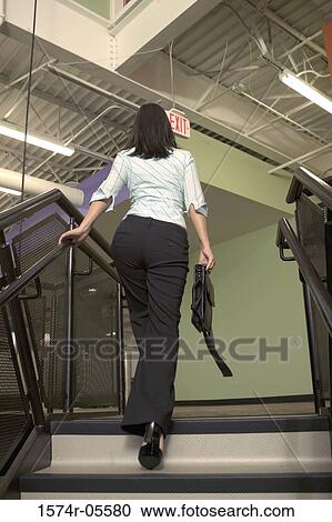 Low angle view of a businesswoman walking up stairs View Large Photo Image Stock Image - Low angle view of a businesswoman walking up stairs. Fotosearch