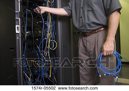 Mid section view of a technician attaching cables to a network server View Large Photo Image Stock Image - Mid section view of a technician attaching cables to a network server. Fotosearch