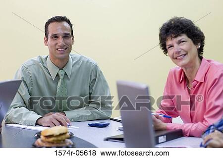 Portrait of a businessman and a businesswoman in a meeting View Large Photo Image Stock Photo - Portrait of a businessman and a businesswoman in a meeting. Fotosearch
