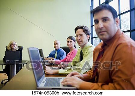 Stock Image - Portrait of a group of business executives in a conference. Fotosearch