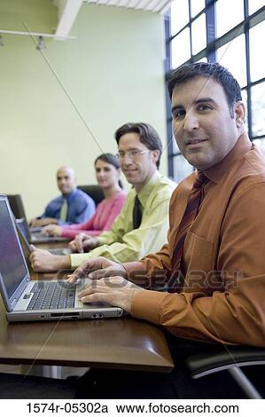Stock Image - Portrait of a group of business executives in a conference. Fotosearch
