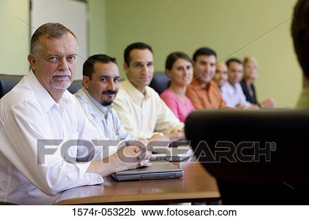 Portrait of a group of business executives sitting around a conference table View Large Photo Image Stock Image - Portrait of a group of business executives sitting around a conference table. Fotosearch