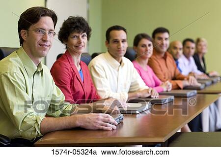 Portrait of a group of business executives sitting around a conference table View Large Photo Image Stock Image - Portrait of a group of business executives sitting around a conference table. Fotosearch