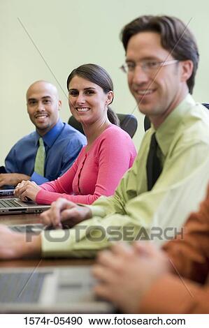 Portrait of a group of business executives sitting around a conference table View Large Photo Image Stock Image - Portrait of a group of business executives sitting around a conference table. Fotosearch