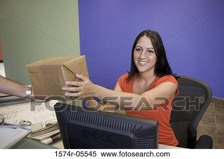 Portrait of a receptionist receiving a package from a delivery man View Large Photo Image Stock Photography - Portrait of a receptionist receiving a package from a delivery man. Fotosearch
