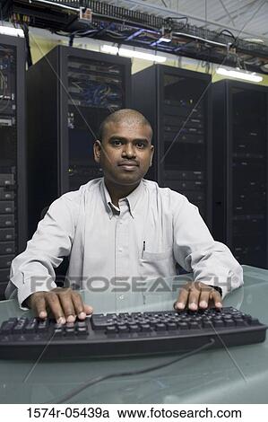 Stock Image - Portrait of a technician working on a network server. Fotosearch