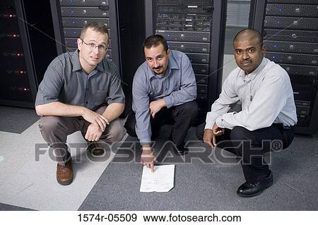Portrait of three technicians crouching in front of a network server View Large Photo Image Stock Photo - Portrait of three technicians crouching in front of a network server. Fotosearch