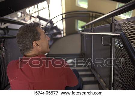 Rear view of a businessman sitting on stairs View Large Photo Image Stock Photo - Rear view of a businessman sitting on stairs. Fotosearch