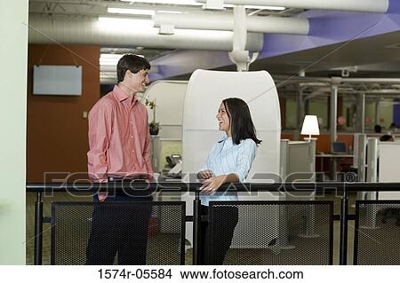 Side profile of a businessman and a businesswoman talking on stairs View Large Photo Image Picture - Side profile of a businessman and a businesswoman talking on stairs. Fotosearch