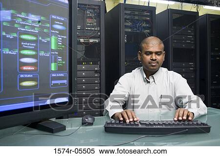 Stock Photography - Technician working on a network server. Fotosearch