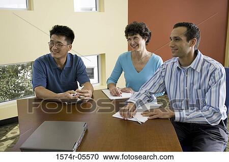 Two businessmen and a businesswoman in a conference View Large Photo Image Stock Image - Two businessmen and a businesswoman in a conference. Fotosearch