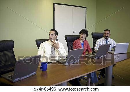 Two businessmen and a businesswoman in a conference View Large Photo Image Stock Photograph - Two businessmen and a businesswoman in a conference. Fotosearch