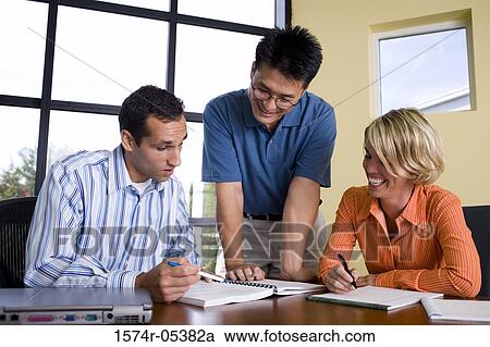 Two businessmen and a businesswoman reading documents View Large Photo Image Stock Image - Two businessmen and a businesswoman reading documents. Fotosearch