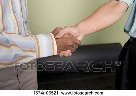 Two businessmen shaking hands View Large Photo Image Stock Image - Two businessmen shaking hands. Fotosearch