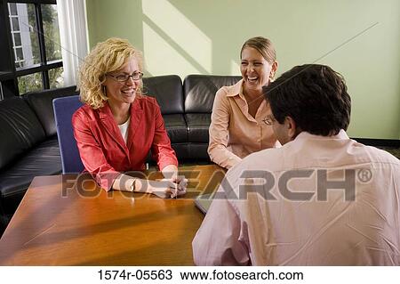 Two businesswomen and a businessman in a conference View Large Photo Image Stock Image - Two businesswomen and a businessman in a conference. Fotosearch