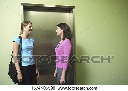 Two businesswomen waiting for an elevator View Large Photo Image Stock Photo - Two businesswomen waiting for an elevator. Fotosearch