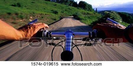 Stock Photography - Close-up of a person's hands gripping the handlebar of a mountain bike. Fotosearch