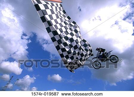 Low angle view of a man performing stunts on a motorcycle View Large Photo Image Stock Photo - Low angle view of a man performing stunts on a motorcycle. Fotosearch