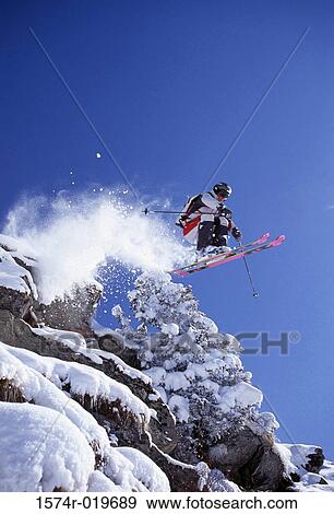 Low angle view of a man skiing View Large Photo Image Stock Photo - Low angle view of a man skiing. Fotosearch