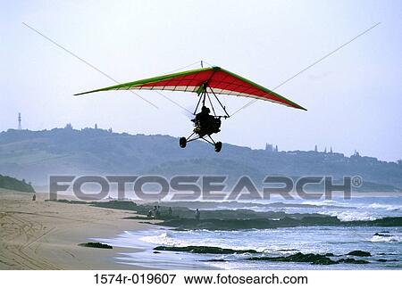 Low angle view of a person flying an ultralight View Large Photo Image Stock Photo - Low angle view of a person flying an ultralight. Fotosearch