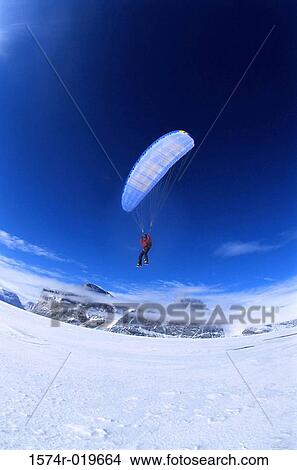 Low angle view of a person paragliding View Large Photo Image Picture - Low angle view of a person paragliding. Fotosearch