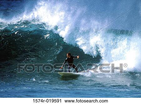 Mid adult man surfing in the sea View Large Photo Image Stock Image - Mid adult man surfing in the sea. Fotosearch