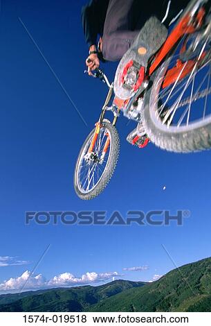 Person performing stunt on mountain bike View Large Photo Image Stock Photo - Person performing stunt on mountain bike. Fotosearch