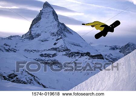 Stock Photo - Side profile of a man snowboarding. Fotosearch
