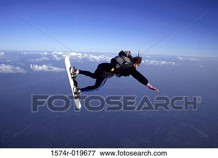 Stock Photo - Side profile of a person skysurfing. Fotosearch